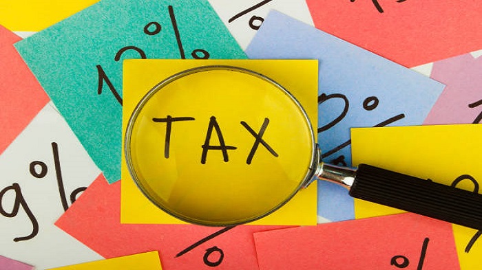 Arrière-plan composé de différents autocollants avec le mot tax - constituer une société à Madagascar - Activ Solutions