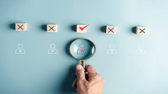 une main tenant une loupe à la recherche du bon prestataire de service - externalisation de services - activsolutions